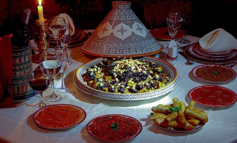 Traditional multi-course Moroccan feast served in palatial surroundings
