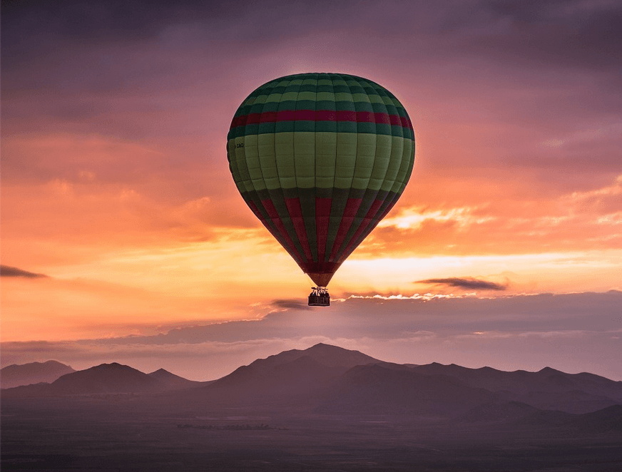 Aerial sunrise view of desert plains and Atlas mountain silhouettes