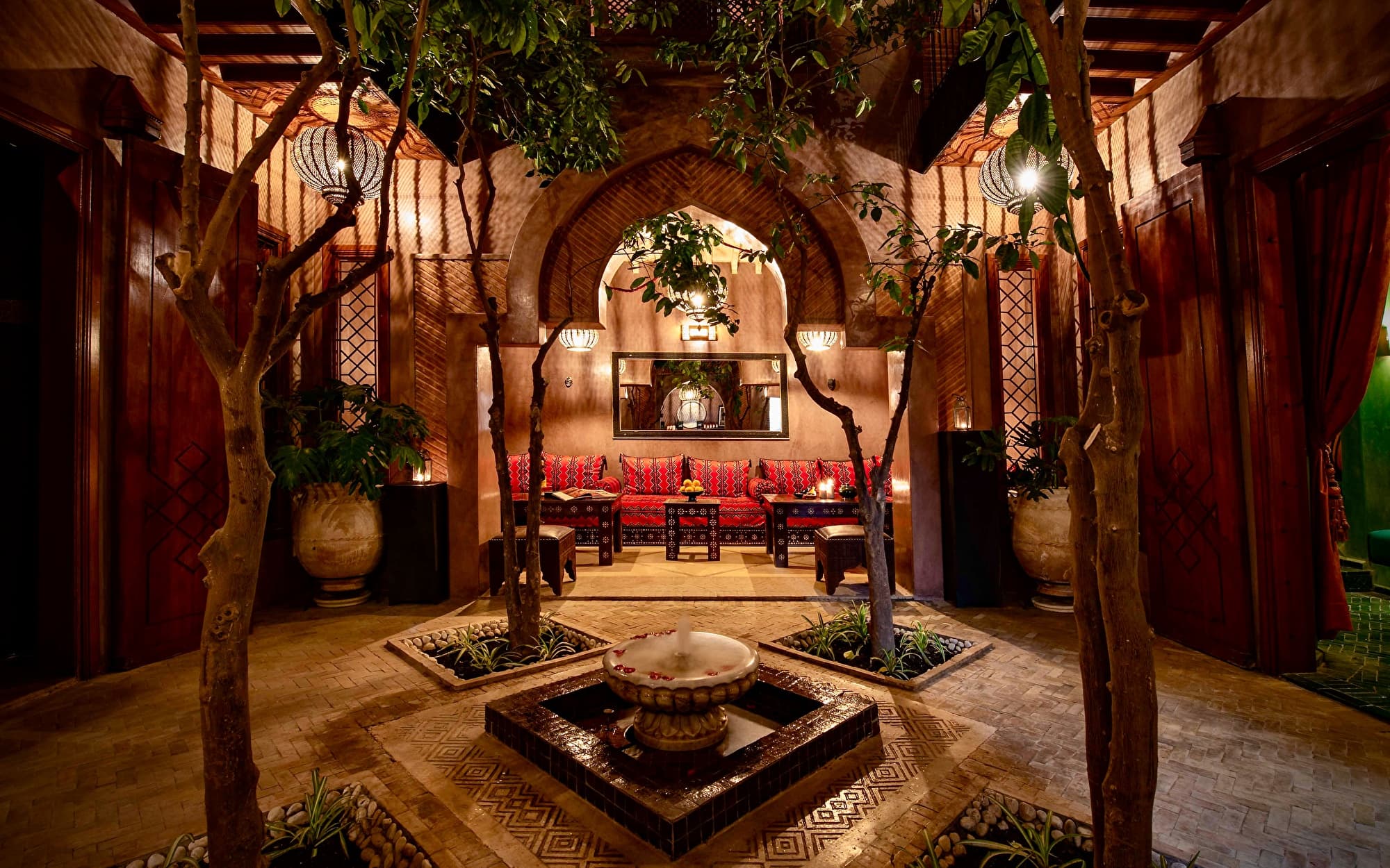 Tranquil traditional riad courtyard with swimming pool and lanterns in Morocco