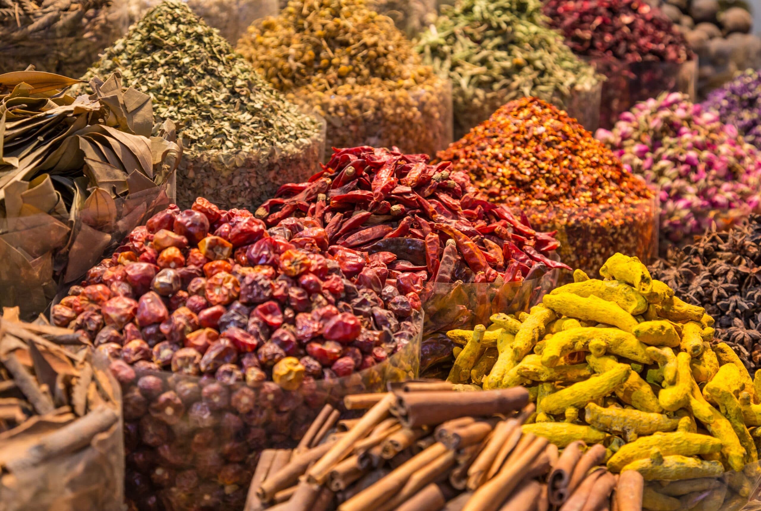 Mounds of colorful spices displayed in woven baskets at a spice merchant in Marrakech